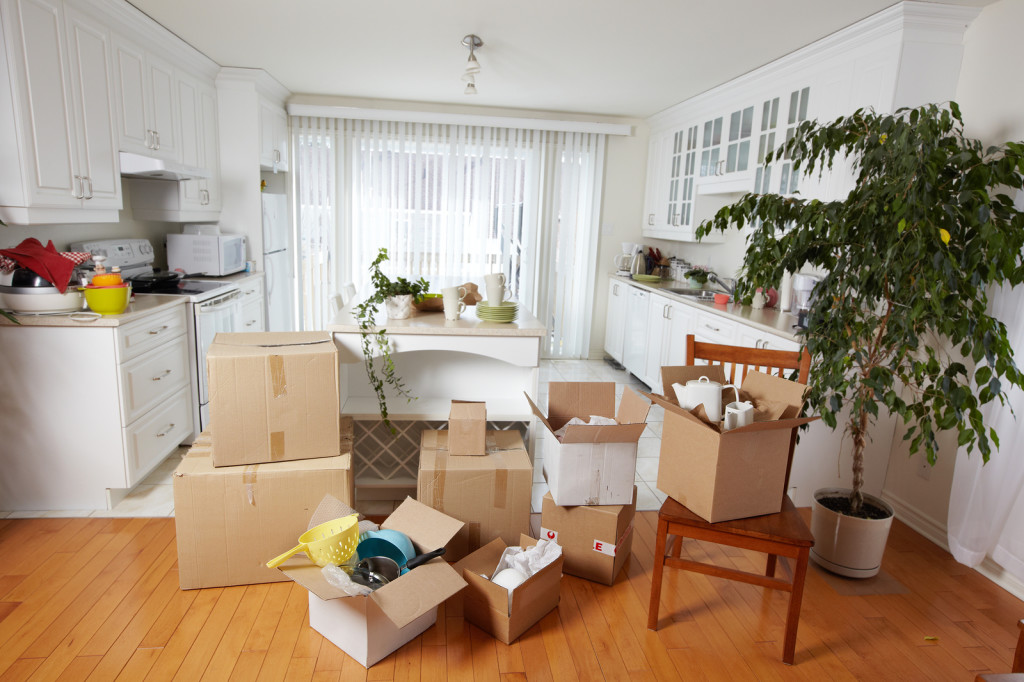 Moving boxes in new house. New apartment background.